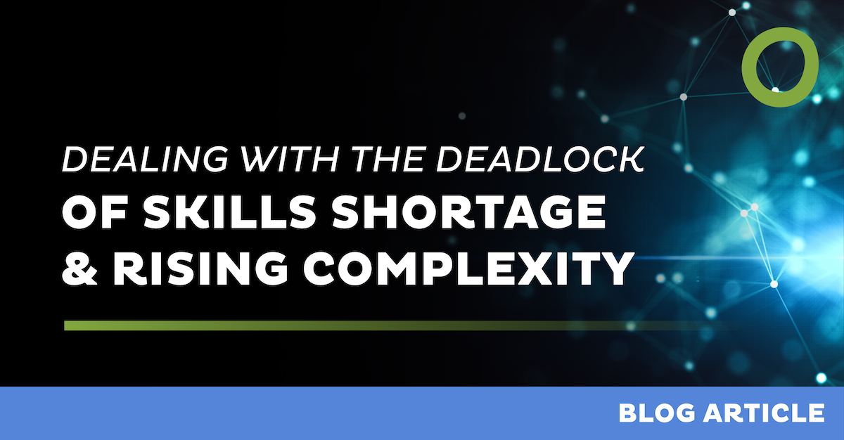 Text graphic with a dark background featuring a blog article title: "Dealing with the Deadlock of Skills Shortage & Rising Complexity." The bottom section has a blue strip with the words "Blog Article" in white. A green circle design is on the upper right.