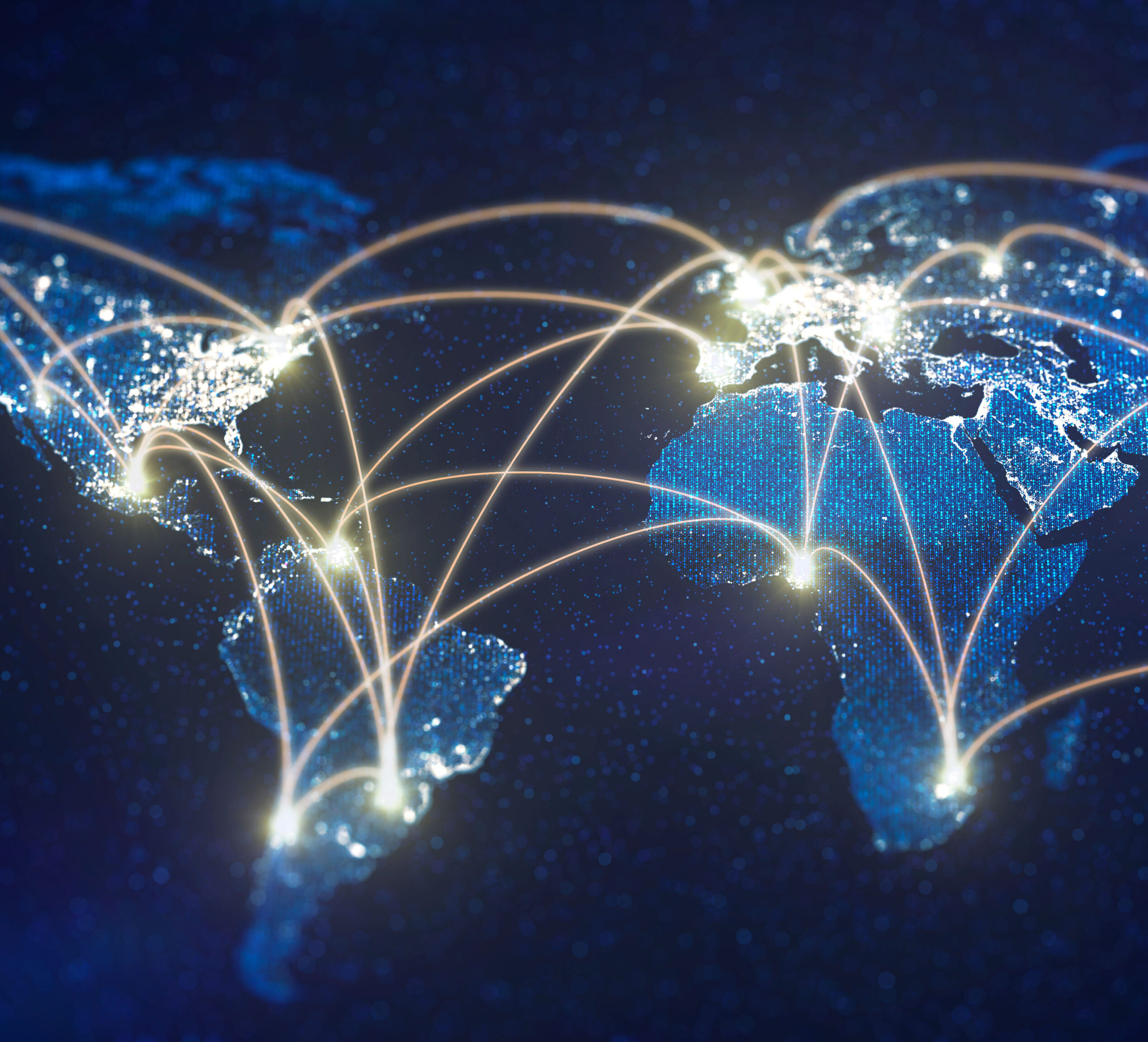 Une carte du monde avec des lignes lumineuses reliant différents points, illustrant un réseau mondial. Les lignes créent un réseau de connexions, suggérant des voies de communication ou commerciales, sur un fond bleu foncé parsemé de lumières.